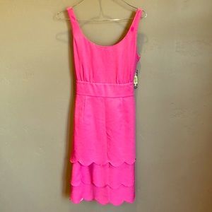 Pink dress with bow on back and scalloped bottom